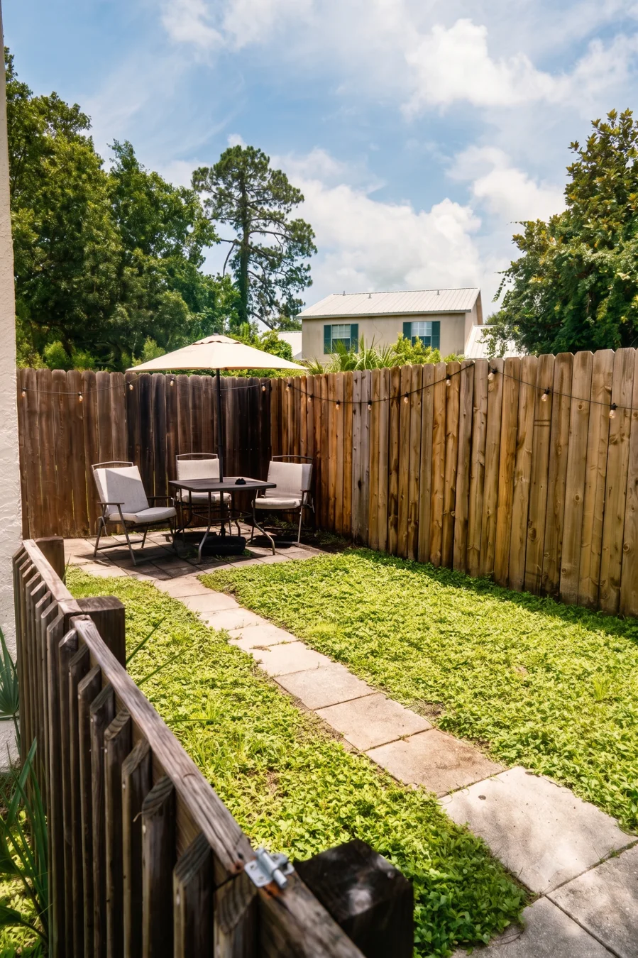 Private fenced backyard with outdoor seating at 6319